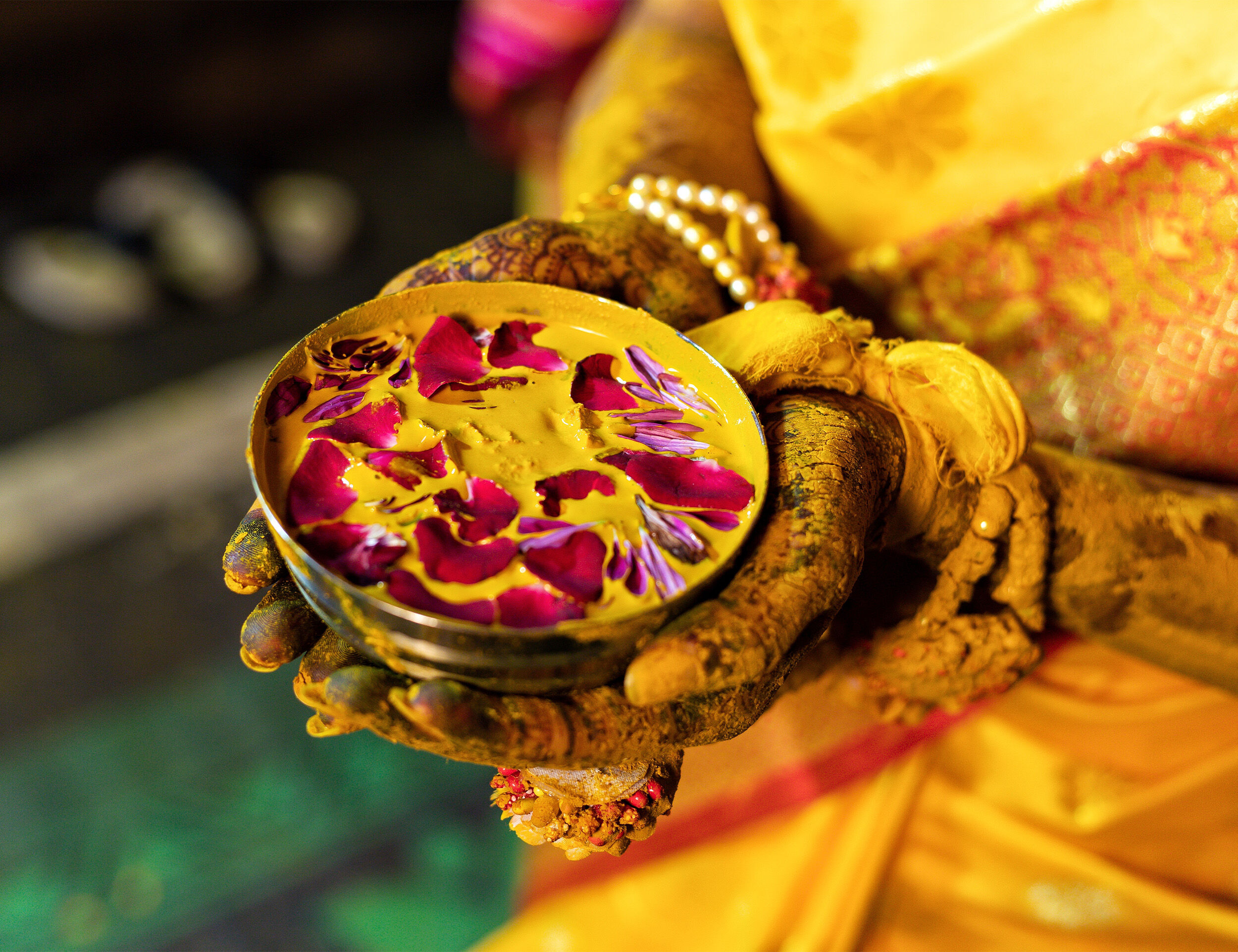 a bride with haldi filled pot in her hand at Indian wedding 